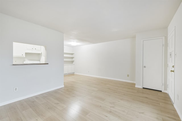 4500 Sherwood Ln Unit 8, Houston, TX 77092 - unfurnished living room featuring light wood finished floors and baseboards