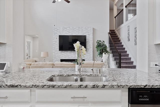 3823 Fleetwood Falls Ln, Spring, TX 77386 - kitchen with ceiling fan, light stone countertops, dishwasher, white cabinets, and open floor plan