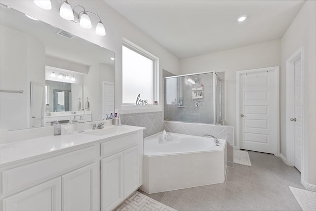 3823 Fleetwood Falls Ln, Spring, TX 77386 - bathroom featuring a garden tub, tile patterned flooring, vanity, a stall shower, and recessed lighting