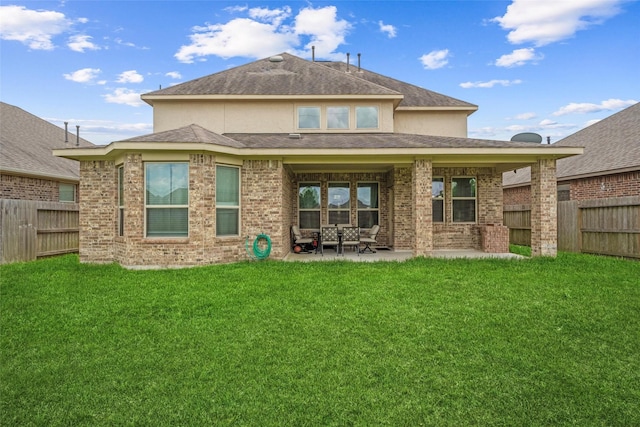 3823 Fleetwood Falls Ln, Spring, TX 77386 - back of property with a fenced backyard, a patio, brick siding, and roof with shingles