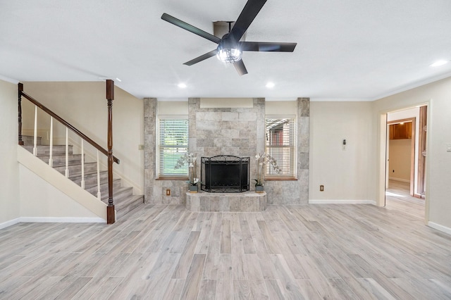 214 Caleta Cir, Richmond, TX 77406 - unfurnished living room featuring wood finished floors, stairway, a fireplace, ceiling fan, and recessed lighting