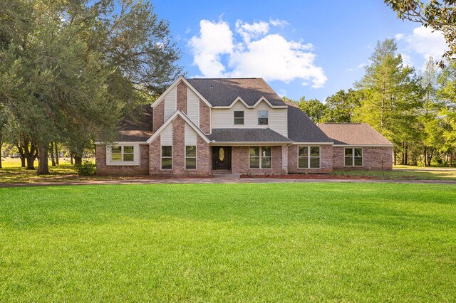 214 Caleta Cir, Richmond, TX 77406 - view of front of property with a front yard, brick siding, and roof with shingles