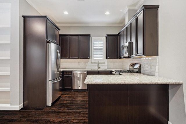 1707 Crockett St Unit A, Houston, TX 77007 - kitchen with stainless steel appliances, a peninsula, crown molding, dark wood-type flooring, and backsplash