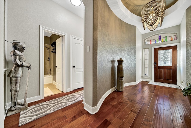 66 N Rocky Point Cir, Spring, TX 77389 - foyer featuring a chandelier, a textured wall, and dark wood-type flooring