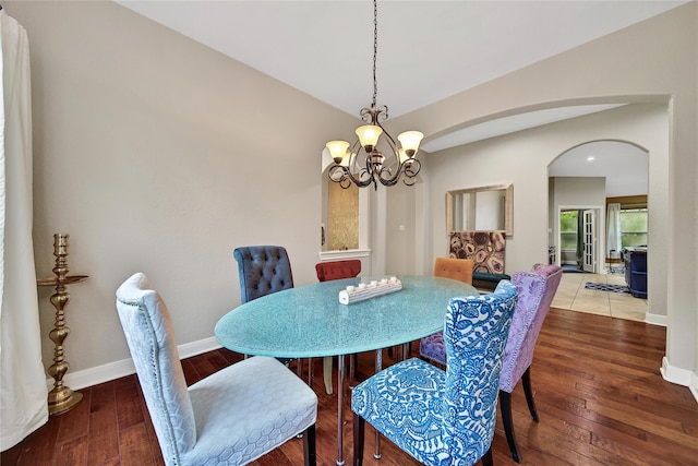 66 N Rocky Point Cir, Spring, TX 77389 - dining space featuring arched walkways, a chandelier, and hardwood / wood-style floors