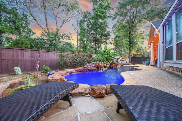 66 N Rocky Point Cir, Spring, TX 77389 - pool at dusk with a patio and a fenced backyard