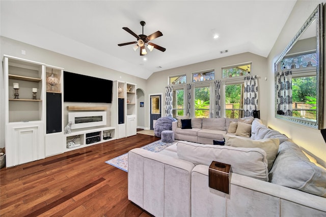 66 N Rocky Point Cir, Spring, TX 77389 - living room with vaulted ceiling, ceiling fan, dark wood-type flooring, arched walkways, and built in features