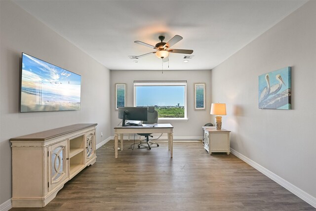 3914 Curlew Dr, Galveston, TX 77554 - home office featuring a ceiling fan and dark wood-type flooring