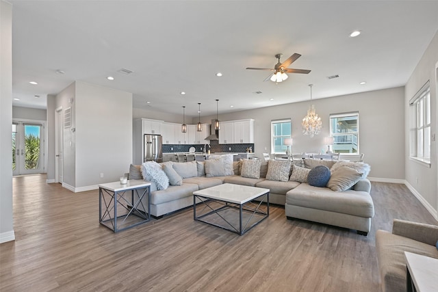 3914 Curlew Dr, Galveston, TX 77554 - living area with light wood-style flooring, ceiling fan, recessed lighting, and a chandelier