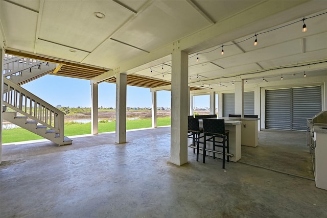 3914 Curlew Dr, Galveston, TX 77554 - view of patio featuring stairway and a water view