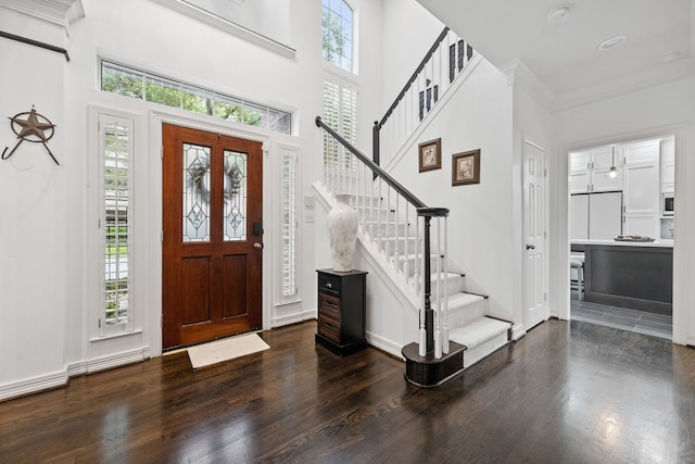 2516 Bagby St, Houston, TX 77006 - foyer entrance with wood finished floors, a towering ceiling, and stairs