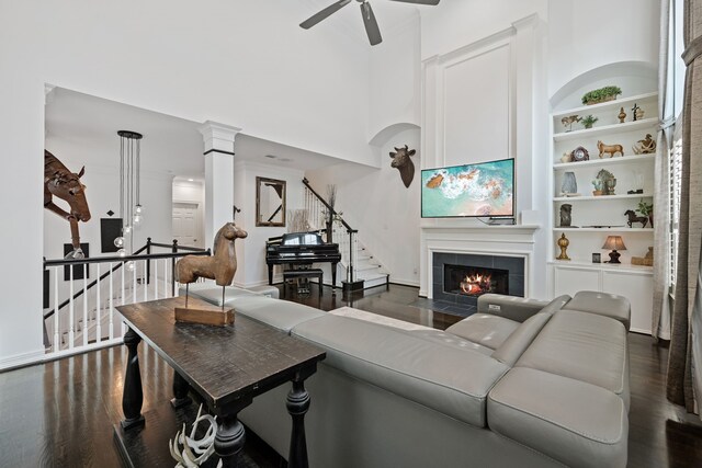 2516 Bagby St, Houston, TX 77006 - living room with built in shelves, dark wood-style flooring, ceiling fan, and a tiled fireplace