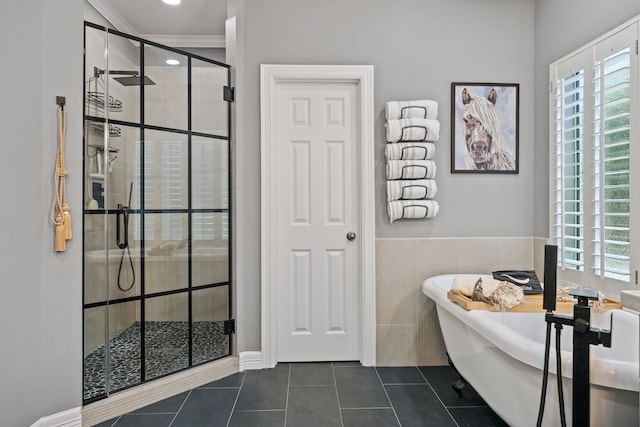 2516 Bagby St, Houston, TX 77006 - bathroom featuring a freestanding bath, tile patterned floors, a shower stall, ornamental molding, and tile walls