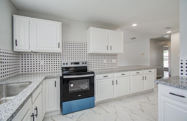 2207 S Ferrisburg Ct, Sugar Land, TX 77478 - kitchen with stainless steel range with electric stovetop, light marble finish flooring, white cabinets, light stone counters, and recessed lighting