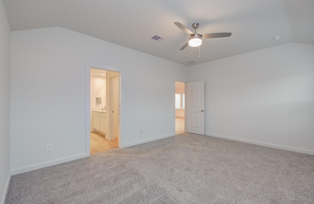 2207 S Ferrisburg Ct, Sugar Land, TX 77478 - unfurnished bedroom featuring lofted ceiling, light colored carpet, connected bathroom, and a ceiling fan