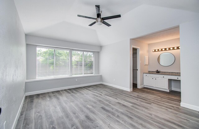 2207 S Ferrisburg Ct, Sugar Land, TX 77478 - unfurnished bedroom with wood finished floors, a spacious closet, vaulted ceiling, ensuite bath, and ceiling fan