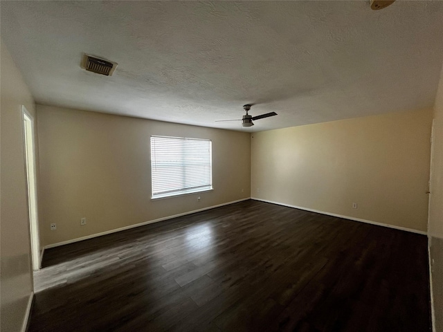 6830 Silver Shores Ln, Katy, TX 77449 - empty room featuring dark wood finished floors, a ceiling fan, and a textured ceiling