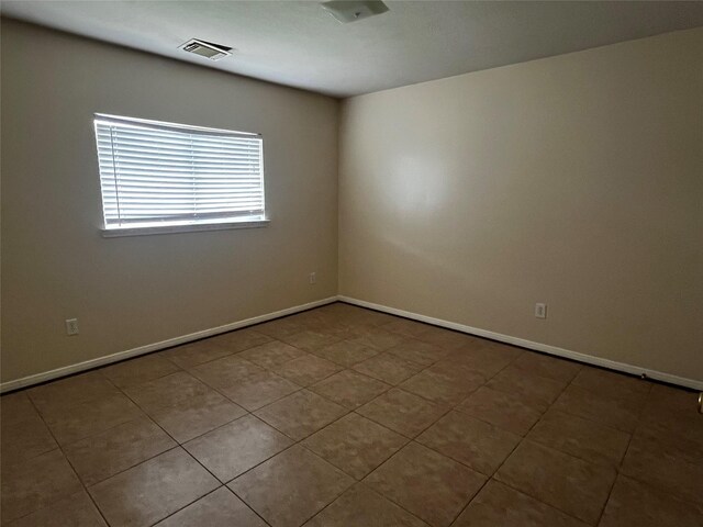 6830 Silver Shores Ln, Katy, TX 77449 - tiled spare room featuring baseboards