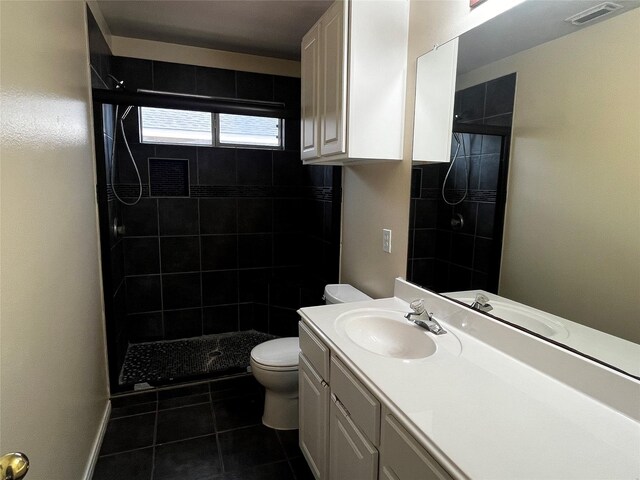 6830 Silver Shores Ln, Katy, TX 77449 - bathroom with vanity, a tile shower, and tile patterned flooring