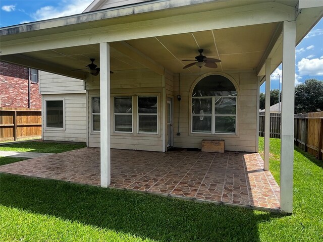 6830 Silver Shores Ln, Katy, TX 77449 - fenced backyard featuring a ceiling fan and a patio