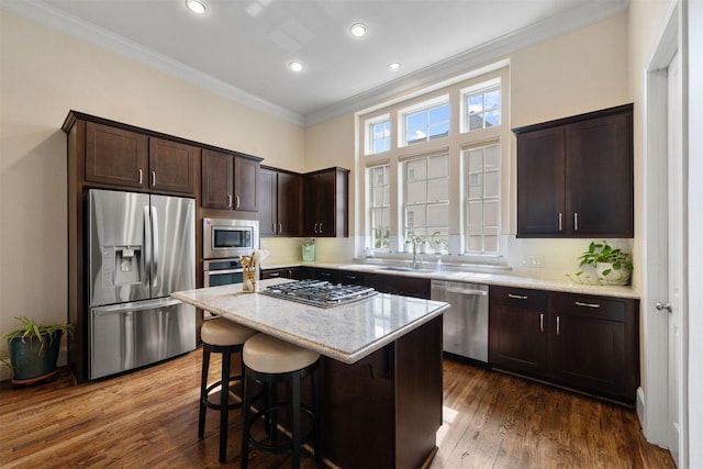 1753 Upland Lks, Houston, TX 77043 - kitchen featuring stainless steel appliances, crown molding, dark brown cabinets, dark wood-type flooring, and light stone countertops