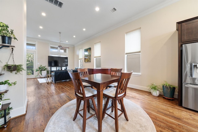 1753 Upland Lks, Houston, TX 77043 - dining area with crown molding, light wood finished floors, recessed lighting, and ceiling fan
