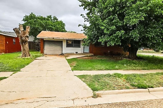 302 52nd St, Lubbock, TX 79404 - view of front of house featuring driveway, a front lawn, a garage, and brick siding