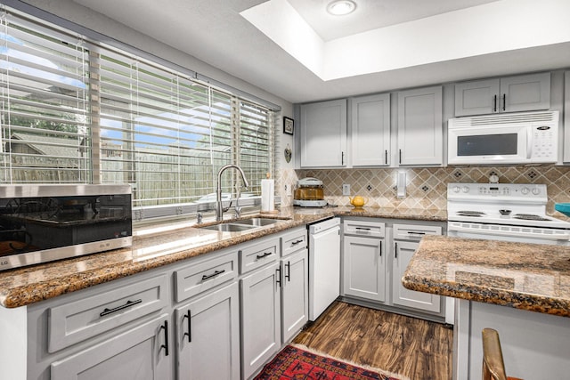 5427 Cairnleigh Dr, Houston, TX 77084 - kitchen with white appliances, dark wood-type flooring, backsplash, and stone countertops
