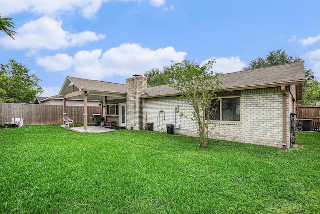 5427 Cairnleigh Dr, Houston, TX 77084 - back of house with a patio area, brick siding, a fenced backyard, a chimney, and roof with shingles