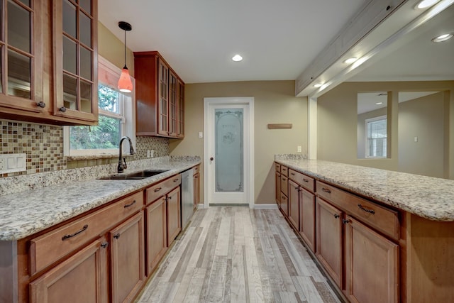 5502 Lincrest Ln, Houston, TX 77056 - kitchen with a peninsula, tasteful backsplash, light wood-style floors, dishwasher, and light stone counters