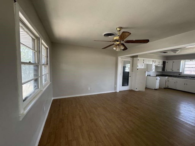 402 51st St, Lubbock, TX 79404 - unfurnished living room featuring dark wood-type flooring and ceiling fan