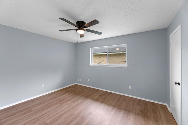 14234 Cellini Dr, Cypress, TX 77429 - spare room with a ceiling fan, wood finished floors, and a textured ceiling
