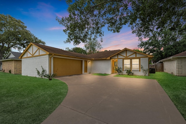 14234 Cellini Dr, Cypress, TX 77429 - tudor home with an attached garage, brick siding, and concrete driveway