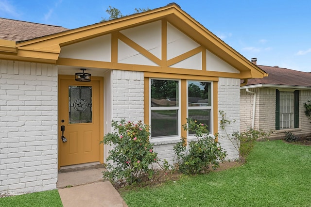 14234 Cellini Dr, Cypress, TX 77429 - doorway to property featuring brick siding, a yard, and roof with shingles