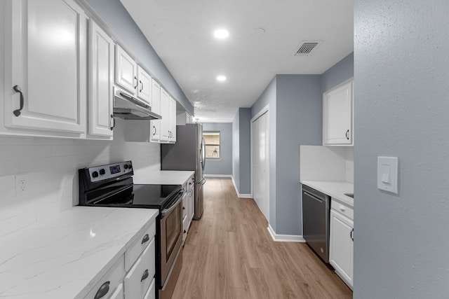 14234 Cellini Dr, Cypress, TX 77429 - kitchen featuring appliances with stainless steel finishes, under cabinet range hood, white cabinets, backsplash, and recessed lighting