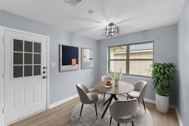 14234 Cellini Dr, Cypress, TX 77429 - dining room with light wood finished floors and a textured ceiling