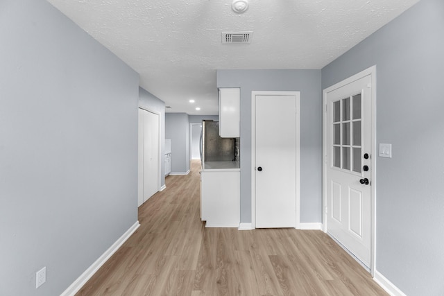 14234 Cellini Dr, Cypress, TX 77429 - hall with light wood-style floors, a textured ceiling, and recessed lighting