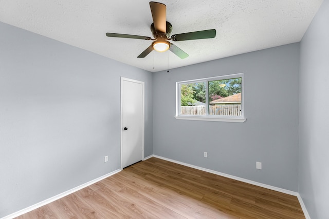 14234 Cellini Dr, Cypress, TX 77429 - unfurnished room with wood finished floors, ceiling fan, and a textured ceiling