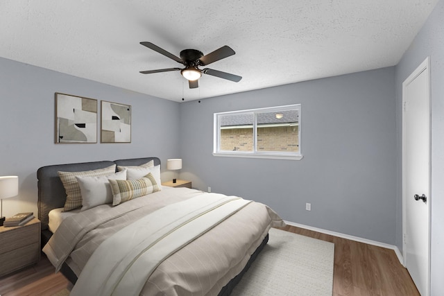 14234 Cellini Dr, Cypress, TX 77429 - bedroom with wood finished floors, a textured ceiling, and ceiling fan