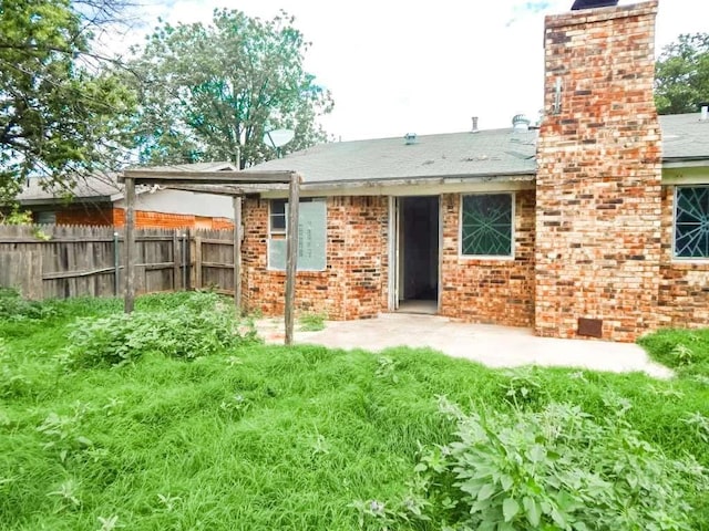 5431 45th St, Lubbock, TX 79414 - rear view of house featuring a chimney and brick siding