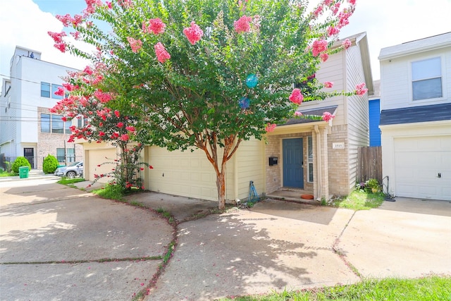 1515 Saulnier St, Houston, TX 77019 - view of property featuring a garage, driveway, and brick siding