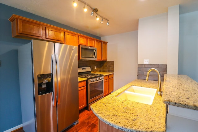 1515 Saulnier St, Houston, TX 77019 - kitchen featuring stainless steel appliances, decorative backsplash, light stone countertops, a peninsula, and dark wood-type flooring