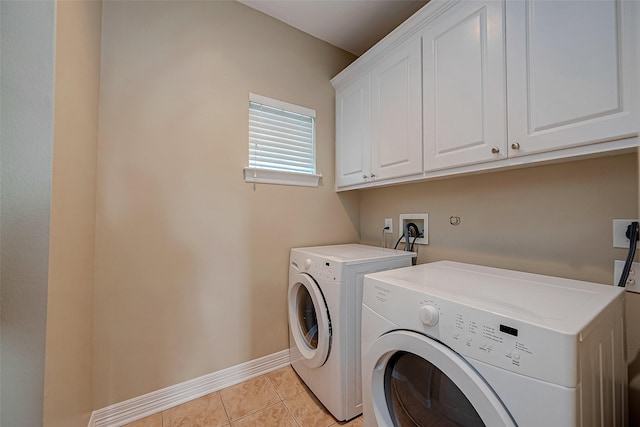 5331 Nolda St Unit A, Houston, TX 77007 - laundry room featuring washing machine and clothes dryer, cabinet space, and light tile patterned flooring