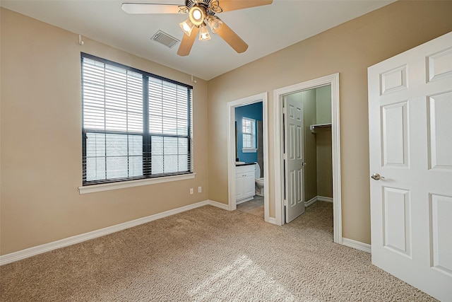 5331 Nolda St Unit A, Houston, TX 77007 - unfurnished bedroom featuring light carpet, a spacious closet, a closet, ensuite bathroom, and a ceiling fan