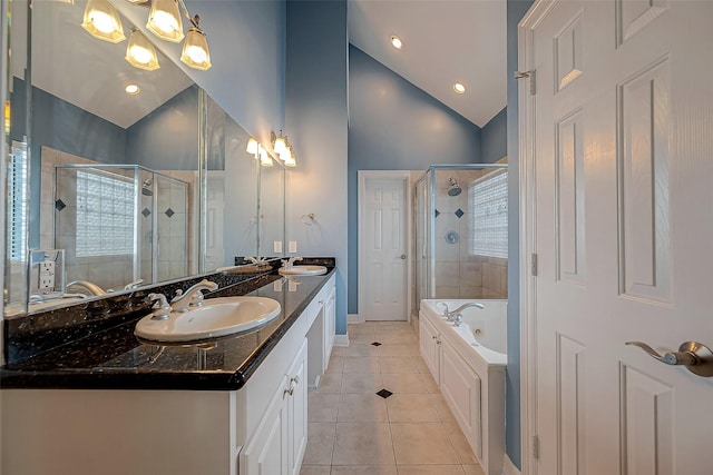 5331 Nolda St Unit A, Houston, TX 77007 - bathroom with tile patterned floors, a stall shower, double vanity, vaulted ceiling, and a whirlpool tub