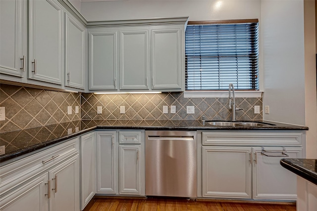 5331 Nolda St Unit A, Houston, TX 77007 - kitchen featuring stainless steel dishwasher, dark stone countertops, tasteful backsplash, and light wood-type flooring