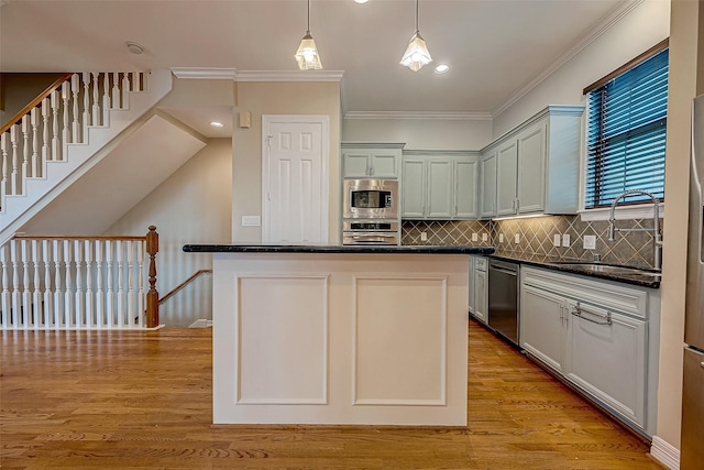 5331 Nolda St Unit A, Houston, TX 77007 - kitchen with appliances with stainless steel finishes, ornamental molding, backsplash, pendant lighting, and light wood-style flooring