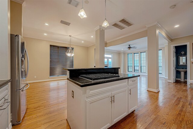 5331 Nolda St Unit A, Houston, TX 77007 - kitchen featuring appliances with stainless steel finishes, open floor plan, crown molding, light wood finished floors, and white cabinets