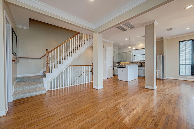 5331 Nolda St Unit A, Houston, TX 77007 - unfurnished living room featuring light wood-type flooring, crown molding, stairway, and recessed lighting