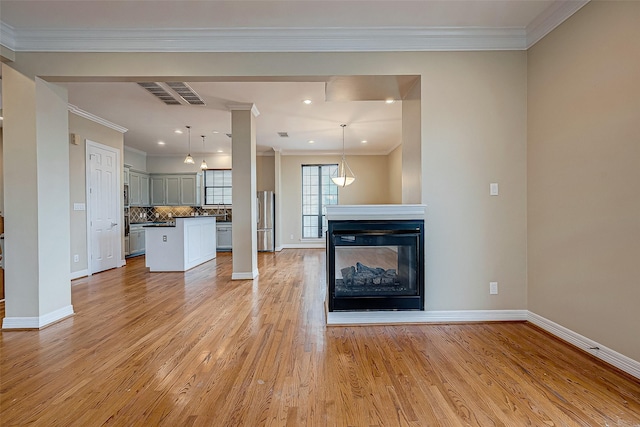 5331 Nolda St Unit A, Houston, TX 77007 - unfurnished living room featuring light wood-style flooring, crown molding, a multi sided fireplace, and recessed lighting